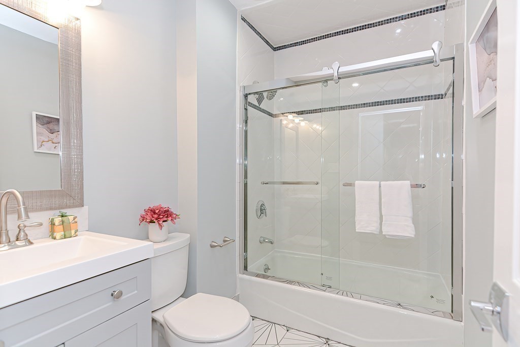 287 Cherry Street, Unit 1 Newton, MA 02465 - Photo 16 of 30 a bathroom with a sink toilet and shower