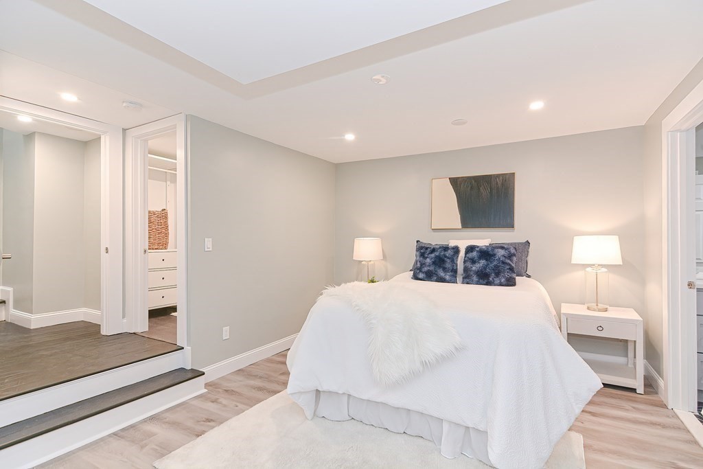 287 Cherry Street, Unit 1 Newton, MA 02465 - Photo 19 of 30 a bedroom with a bed and a large mirror