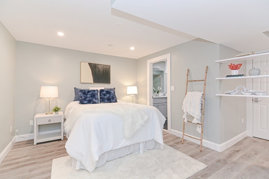 287 Cherry Street, Unit 1 Newton, MA 02465 - Photo 20 of 30 a bedroom with a bed and a refrigerator