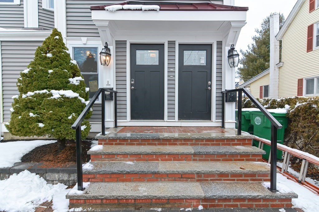 287 Cherry Street, Unit 1 Newton, MA 02465 - Photo 2 of 30 a front view of a house with a yard