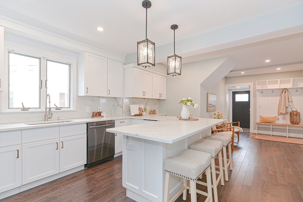 287 Cherry Street, Unit 1 Newton, MA 02465 - Photo 10 of 30 a large kitchen with kitchen island a large island in it