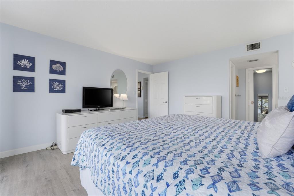 6415 Midnight Pass Road, Unit 310 Sarasota, FL 34242 - Photo 11 of 62 a bedroom with a bed and a flat screen tv