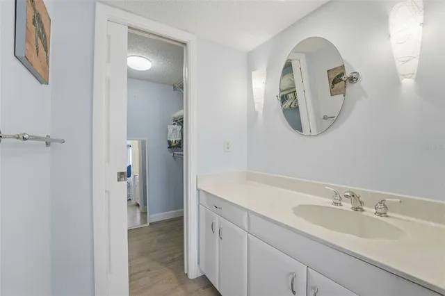 a spacious bathroom with a double vanity sink and a mirror