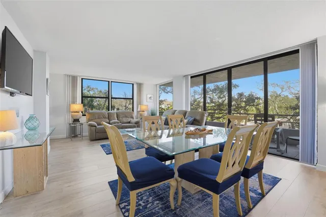 a dining room with furniture and a floor to ceiling window