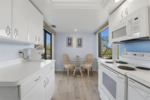 a kitchen with cabinets stainless steel appliances and a sink