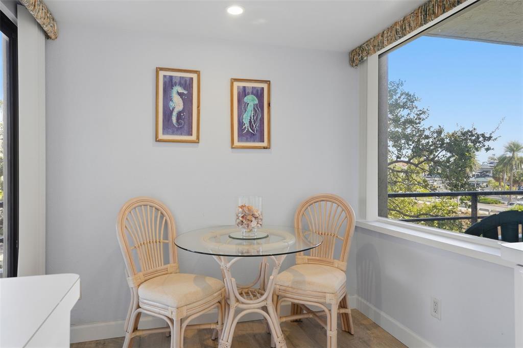 6415 Midnight Pass Road, Unit 310 Sarasota, FL 34242 - Photo 20 of 62 a view of a dining room with furniture window and outside view