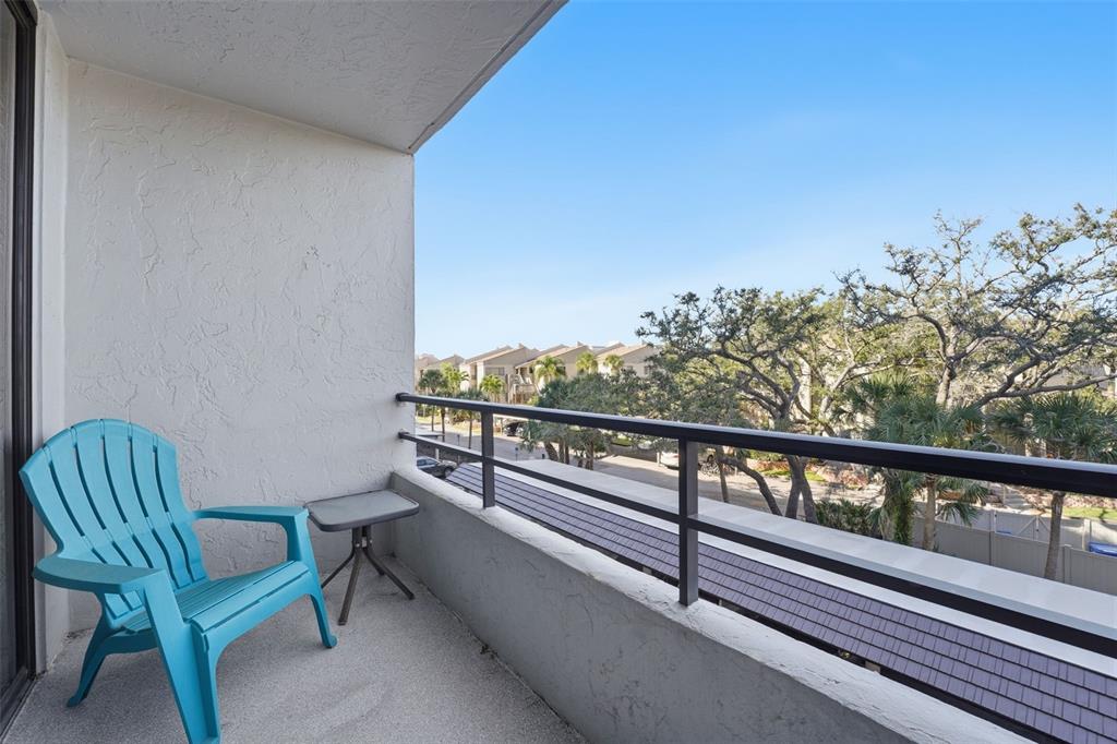 6415 Midnight Pass Road, Unit 310 Sarasota, FL 34242 - Photo 24 of 62 a view of a balcony with chairs