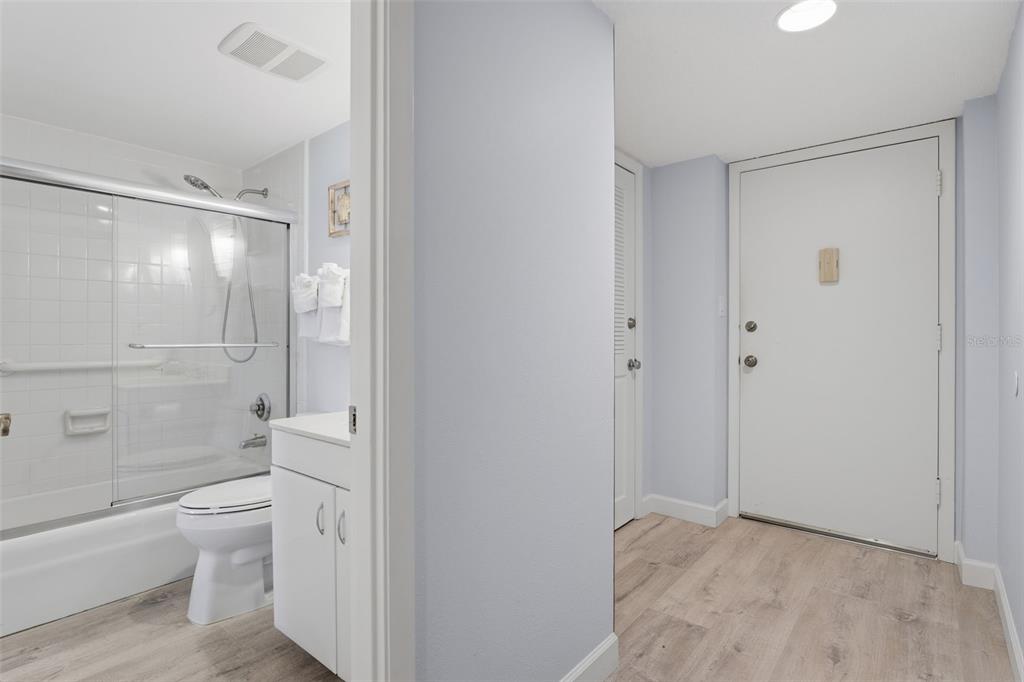 6415 Midnight Pass Road, Unit 310 Sarasota, FL 34242 - Photo 28 of 62 a bathroom with a shower a toilet and a glass door