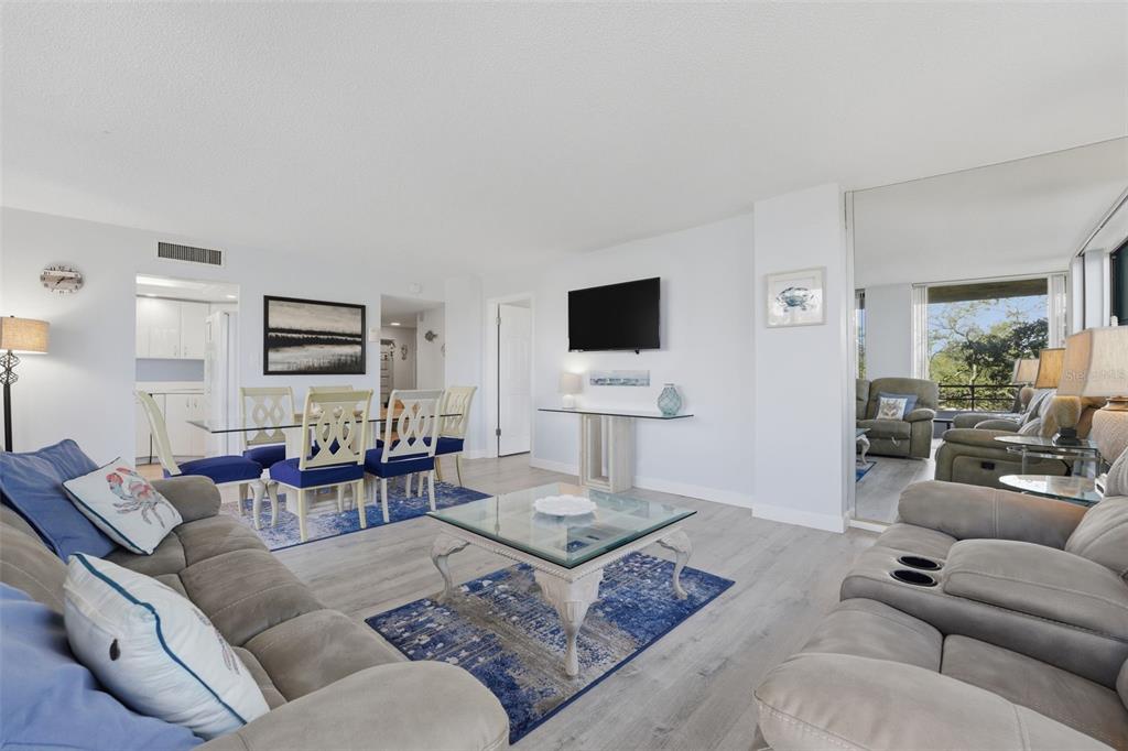 6415 Midnight Pass Road, Unit 310 Sarasota, FL 34242 - Photo 3 of 62 a living room with furniture and a flat screen tv