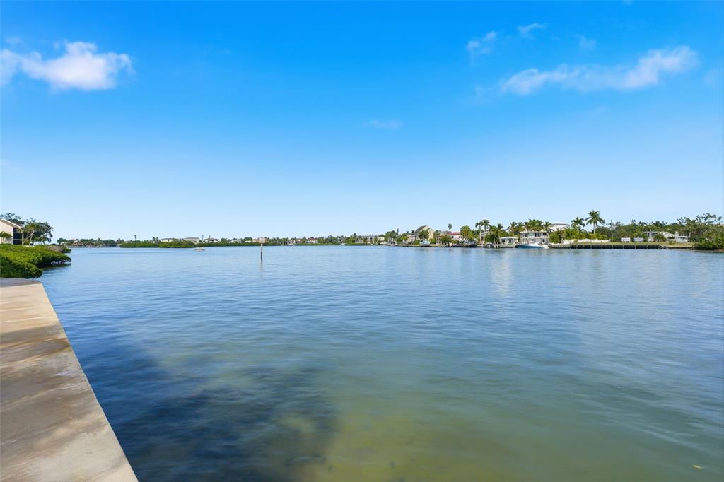 6415 Midnight Pass Road, Unit 310 Sarasota, FL 34242 - Photo 51 of 62 a view of a lake with houses in the background
