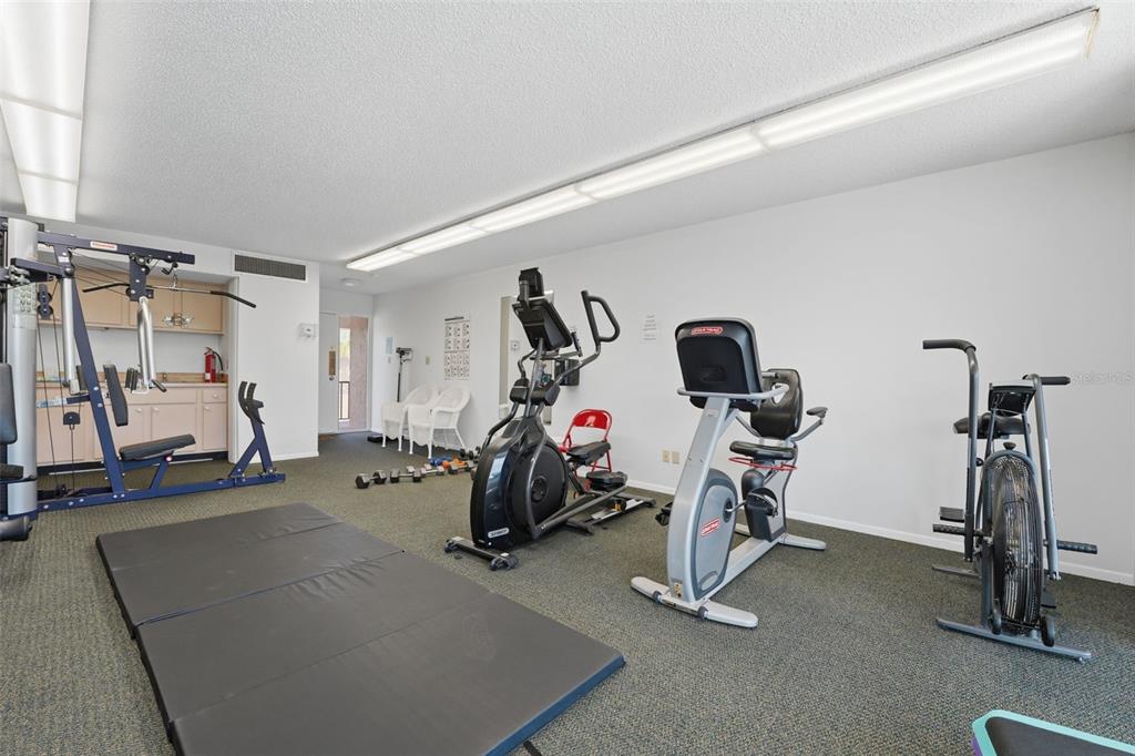 6415 Midnight Pass Road, Unit 310 Sarasota, FL 34242 - Photo 53 of 62 a view of a room with gym equipment