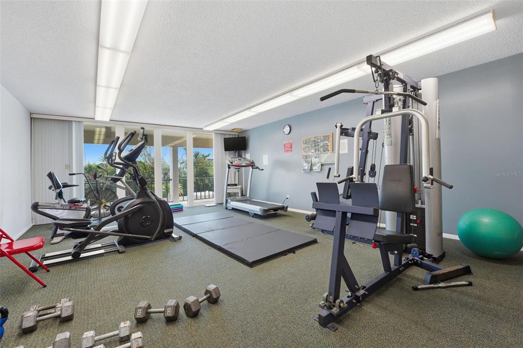 6415 Midnight Pass Road, Unit 310 Sarasota, FL 34242 - Photo 54 of 62 a view of a room with gym equipment