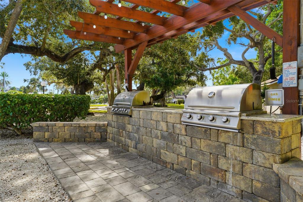 6415 Midnight Pass Road, Unit 310 Sarasota, FL 34242 - Photo 57 of 62 a backyard of a house with fountain plants and large tree