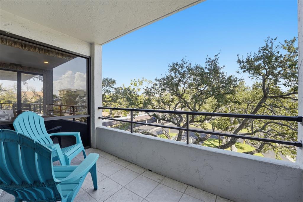 6415 Midnight Pass Road, Unit 310 Sarasota, FL 34242 - Photo 59 of 62 a view of a chairs and table in balcony