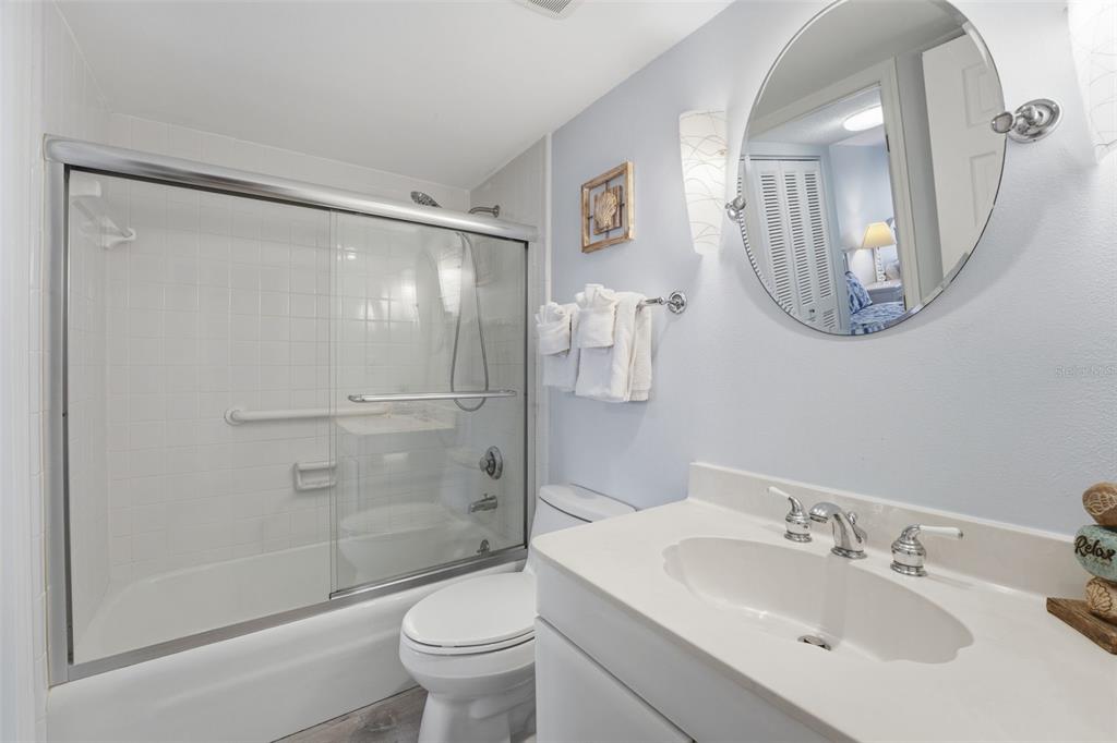 6415 Midnight Pass Road, Unit 310 Sarasota, FL 34242 - Photo 60 of 62 a bathroom with a sink and a mirror