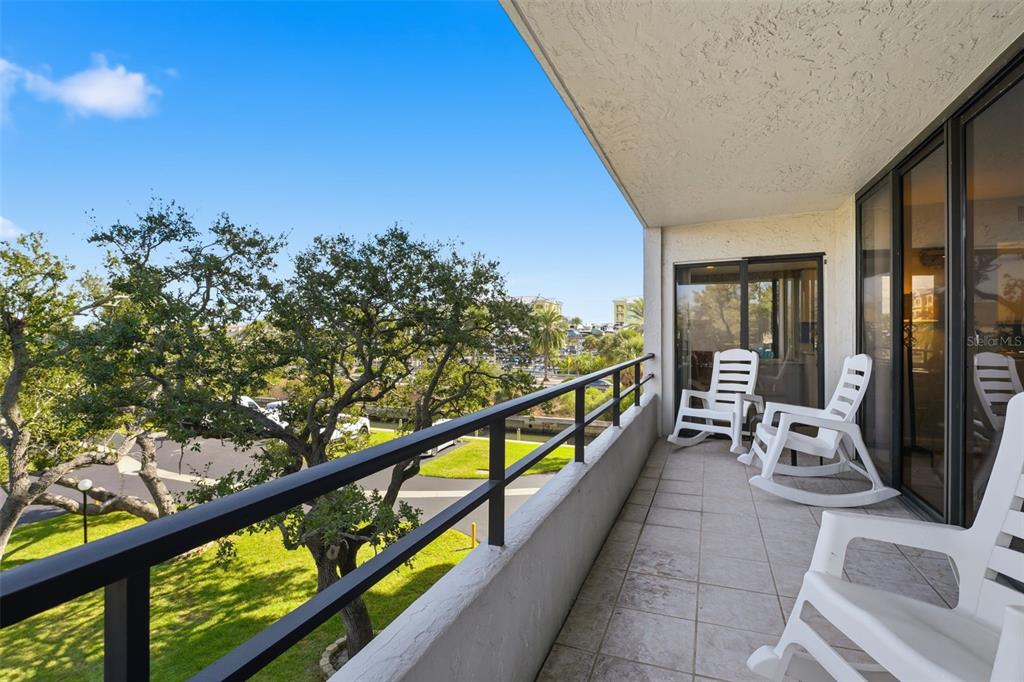 6415 Midnight Pass Road, Unit 310 Sarasota, FL 34242 - Photo 7 of 62 a view of two chairs in the balcony