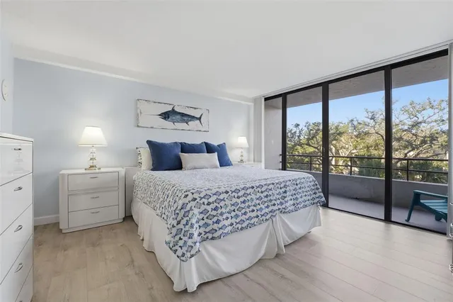 a bedroom with a large bed and a large window