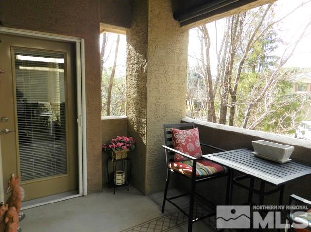 900 S Meadows, Unit 4423 Reno, NV 89521 - Photo 12 of 25 a view of a balcony with chair and wooden floor