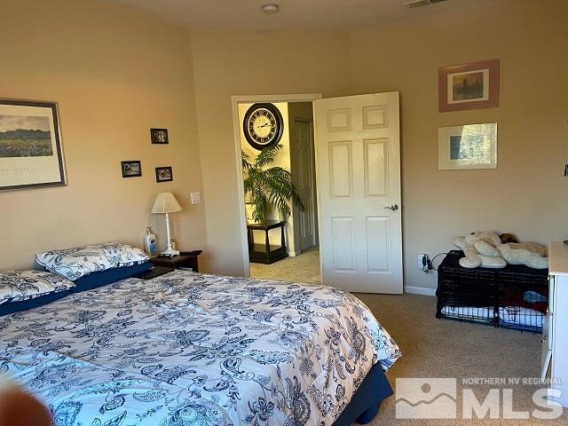 900 S Meadows, Unit 4423 Reno, NV 89521 - Photo 13 of 25 a bedroom with a bed and a lamp on dresser