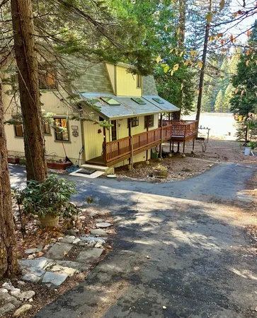 a backyard of a house with table and chairs