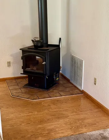 a view of a fireplace with wooden floor