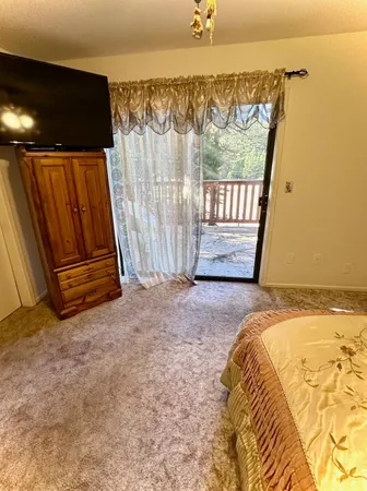 a bed sitting in a bedroom next to a window
