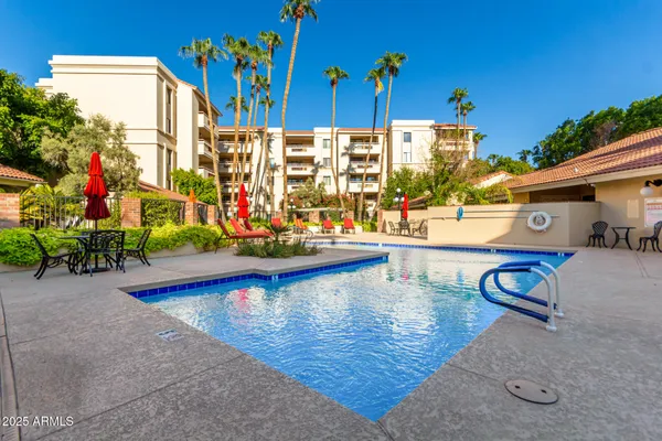 a view of swimming pool with outdoor seating