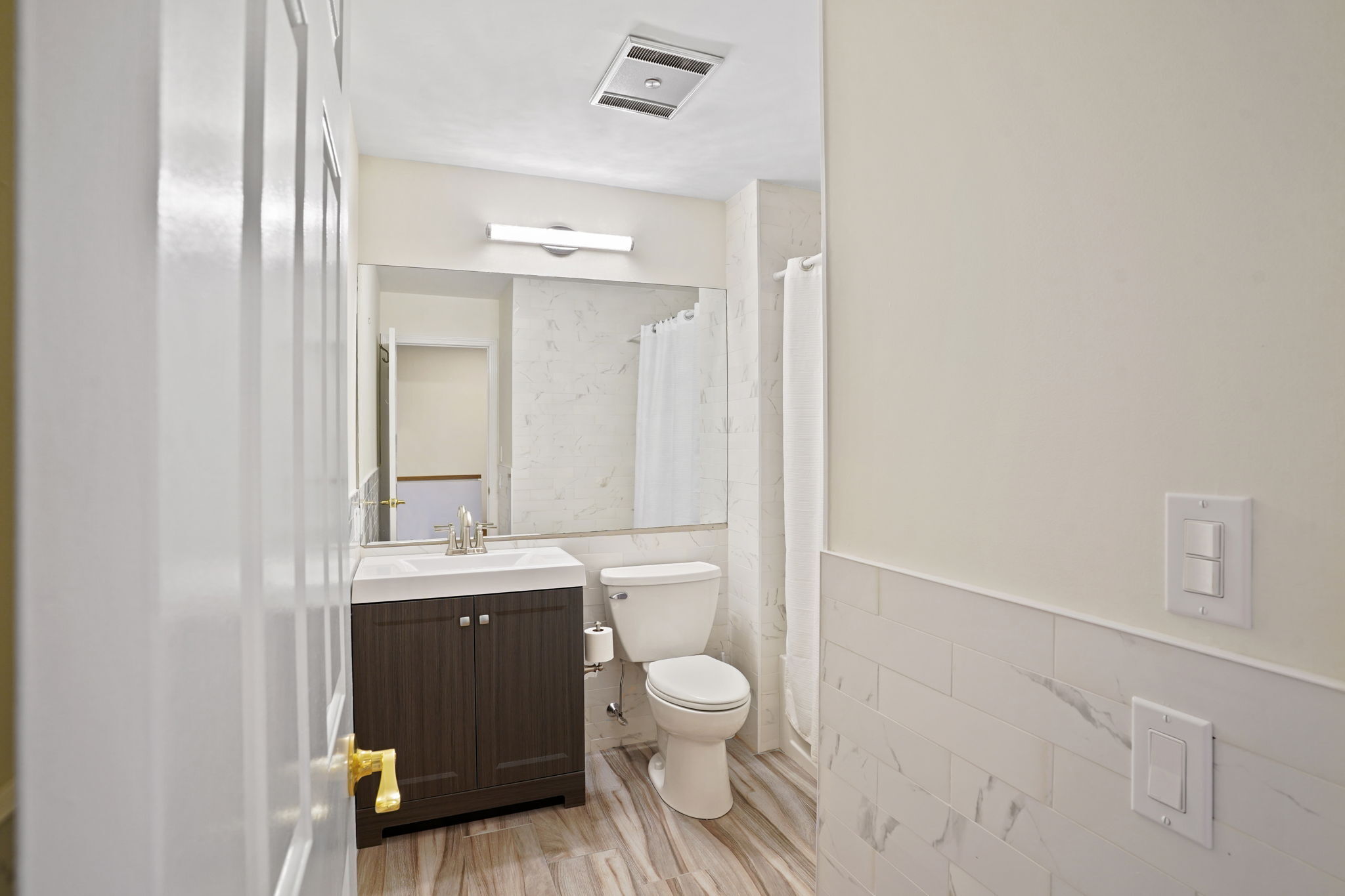 7 River Road, Unit 310 Norwalk, CT 06850 - Photo 13 of 21 a bathroom with a granite countertop toilet a sink and a mirror