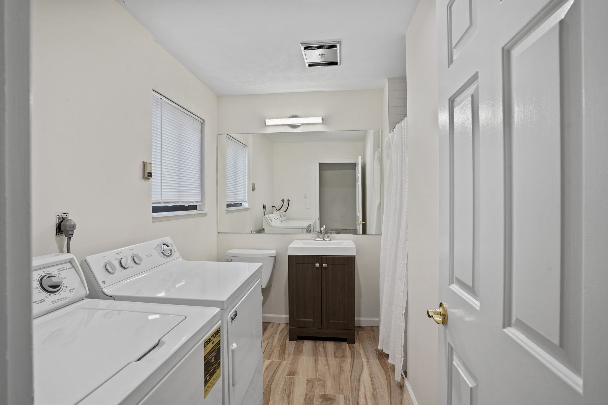 7 River Road, Unit 310 Norwalk, CT 06850 - Photo 3 of 21 a view of a bathroom with a sink and mirror