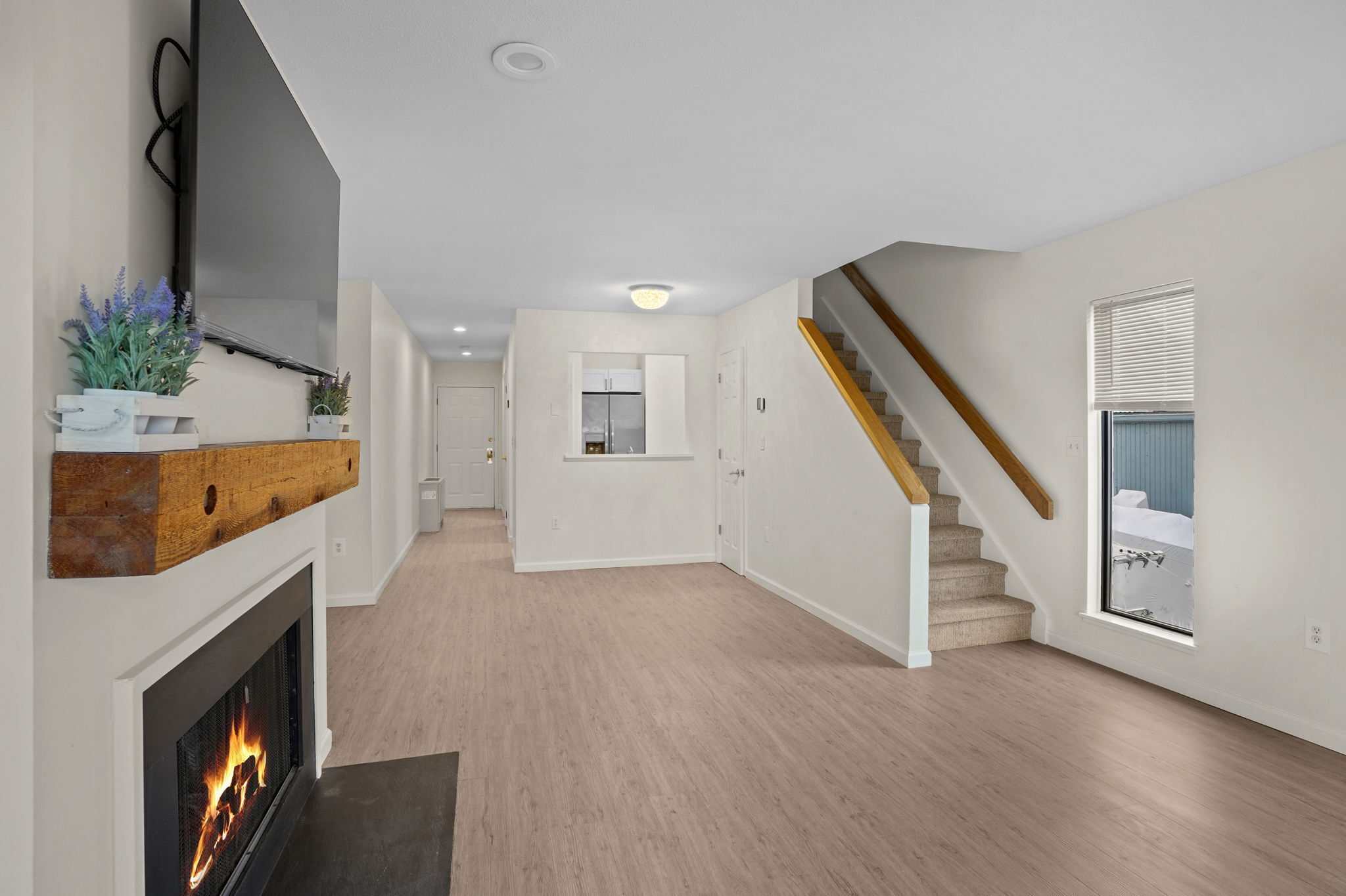 7 River Road, Unit 310 Norwalk, CT 06850 - Photo 8 of 21 a view of an empty room with wooden floor and a fireplace