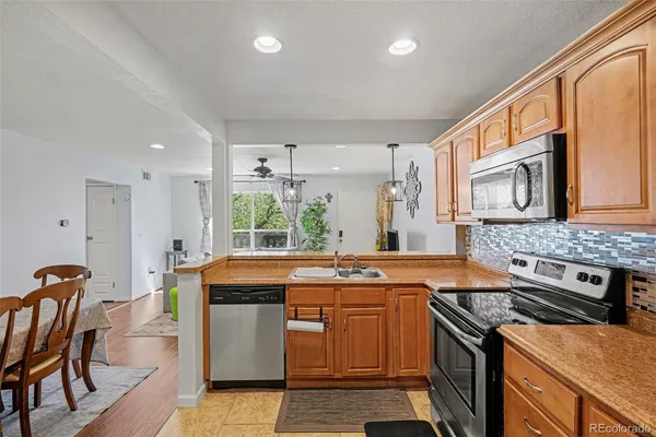 a kitchen with stainless steel appliances granite countertop a stove and a sink