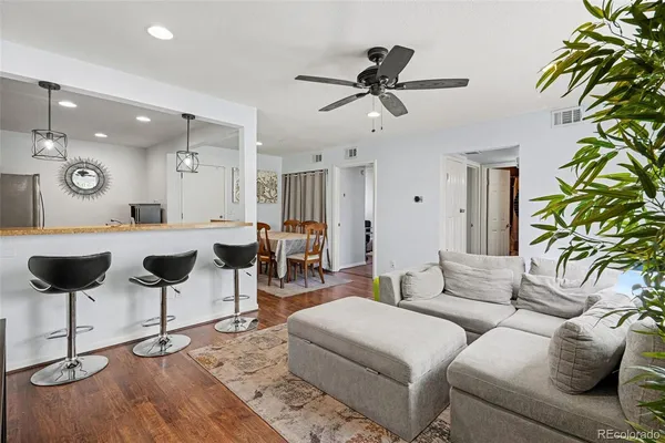 a living room with furniture and a chandelier