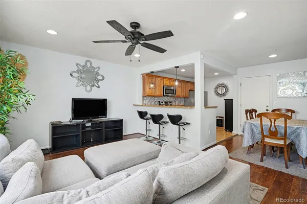 a living room with furniture and a flat screen tv with wooden floor