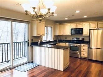 a kitchen with stainless steel appliances a stove a refrigerator and a sink