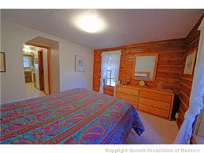 392 Alpine Road Dillon, CO 80435 - Photo 17 of 25 a bedroom with a bed and a dresser