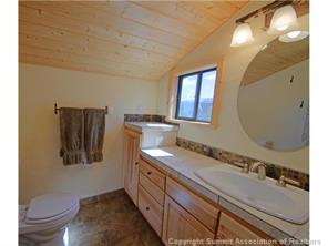 392 Alpine Road Dillon, CO 80435 - Photo 22 of 25 a bathroom with a granite countertop double vanity sink and a mirror