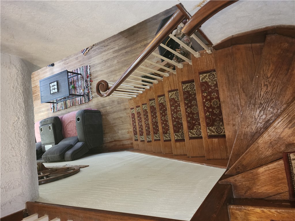 1436 Ruskin Road Dayton, OH 45406 - Photo 17 of 29 This interior showcases natural wood flooring complemented by a elegant staircase with patterned runners.