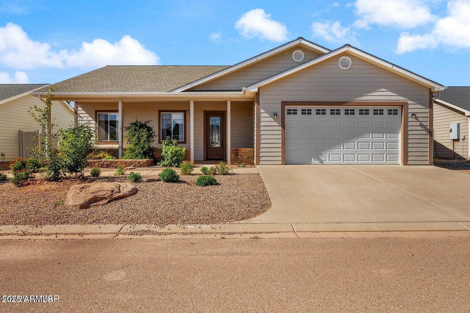 a front view of a house with basket ball court and a garage