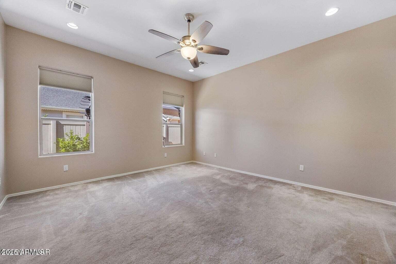 1058 East Adams Street Snowflake, AZ 85937 - Photo 11 of 36 an empty room with windows and chandelier fan