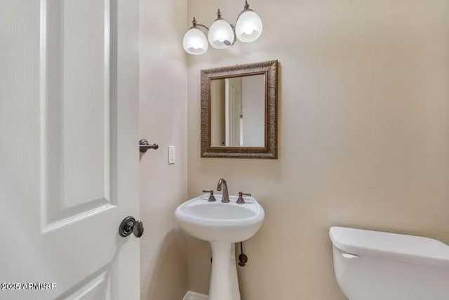 an empty room with windows and fireplace