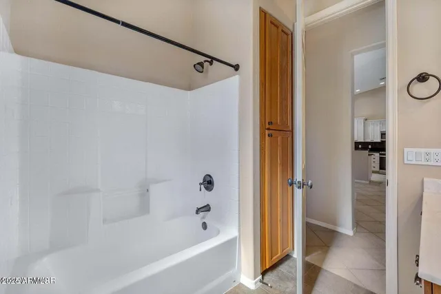 an empty room with a window and a ceiling fan