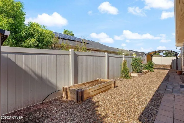 an aerial view of a house with a garden and lake view