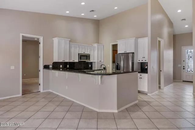 a kitchen with stainless steel appliances a refrigerator sink and microwave