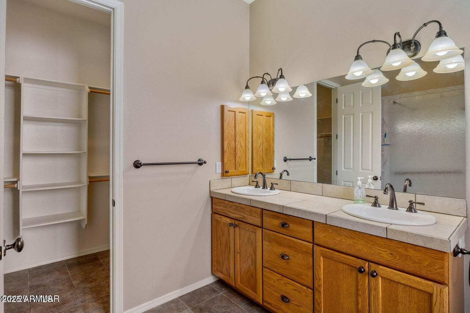1058 East Adams Street Snowflake, AZ 85937 - Photo 8 of 36 a bathroom with a double vanity sink and a mirror