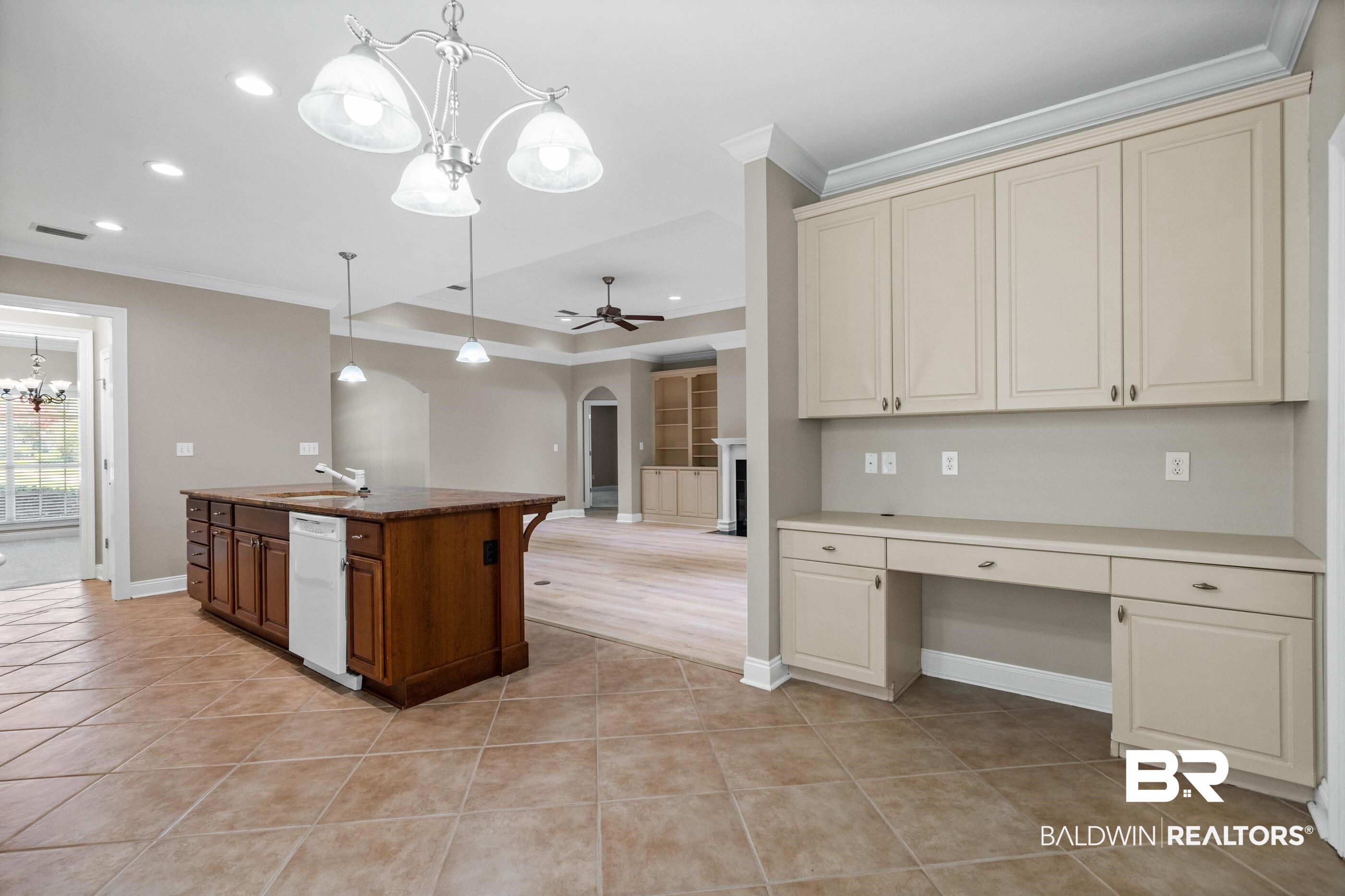 303 Savannah Circle Foley, AL 36535 - Photo 14 of 34 Kitchen area featuring an island with built-in cabinetry, an integrated sink, and a dishwasher