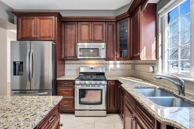 a kitchen with a counter top space a sink and wooden floor