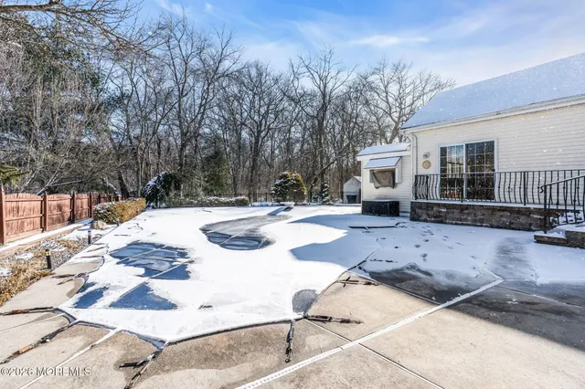 a view of residential house with snow on the road