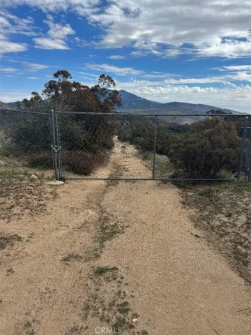 a view of a yard with a wooden fence