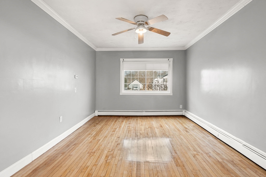70 West High Street, Unit 2 Avon, MA 02322 - Photo 11 of 22 wooden floor in an empty room with a window