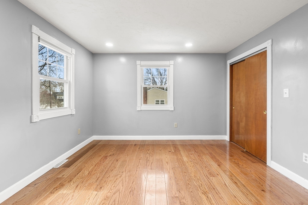 70 West High Street, Unit 2 Avon, MA 02322 - Photo 15 of 22 an empty room with wooden floor and windows